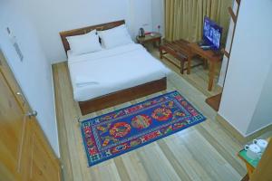 Ένα ή περισσότερα κρεβάτια σε δωμάτιο στο Hotel ZhuSa +1 φωτογραφίες