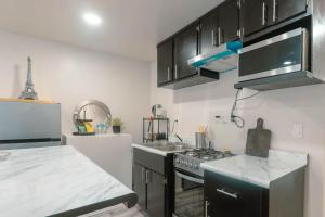 a kitchen with a sink and a stove top oven at Departamento Nuevo in Tijuana