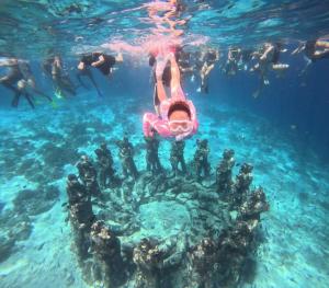 a group of people swimming in the water at Penempuran cottage in Masbagik