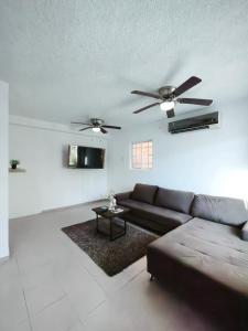a living room with a couch and a ceiling fan at well-deserved rest in Cancun in Cancún