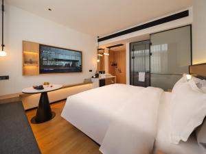 Ένα ή περισσότερα κρεβάτια σε δωμάτιο στο Clouds April Hotel, Dianchi South Asia Style First City Branch +29 φωτογραφίες