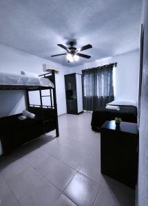 a room with two bunk beds and a ceiling fan at well-deserved rest in Cancun in Cancún