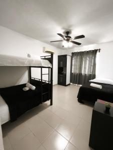a bedroom with two bunk beds and a ceiling fan at well-deserved rest in Cancun in Cancún
