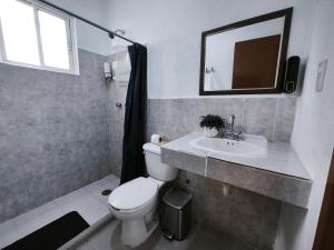 a bathroom with a toilet and a sink and a mirror at well-deserved rest in Cancun in Cancún +30 photos