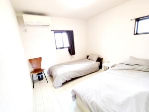 Ένα ή περισσότερα κρεβάτια σε δωμάτιο στο 12名迄OK 5LDK ビーチまで徒歩3分 BBQ完備 駐車場5台White sun villa