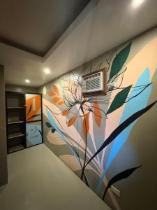 a room with a flower mural on the wall at Coluradel Hostel 