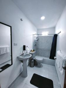 a white bathroom with a sink and a toilet at well-deserved rest in Cancun in Cancún