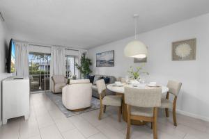a dining room and living room with a table and chairs at The Naples Beach Retreat in Naples