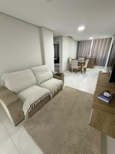 a living room with a couch and a table at Apartment in Brava, 950m from the sea! in Itajaí