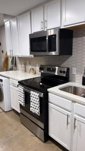 a kitchen with a black stove and a microwave at Opulent Oasis Located in The Heart of Birmingham in Birmingham