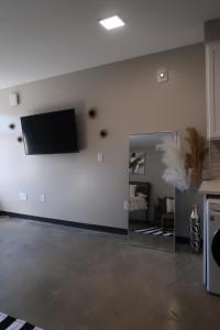 a living room with a flat screen tv on a wall at Opulent Oasis Located in The Heart of Birmingham in Birmingham