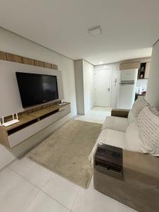 a large living room with a flat screen tv at Apartment in Brava, 950m from the sea! in Itajaí +52 photos