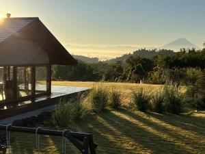 a house with a view of a field and mountains at ヴィラグリファーム七里岩 in Nirasaki +44 photos