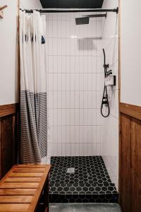 a shower with a black and white shower curtain at Lakefront Safari Tent with Fire Pit and Sauna in North Woodstock, New Hampshire in Woodstock