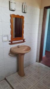 a bathroom with a sink and a mirror at Casa Argentina in Limpio