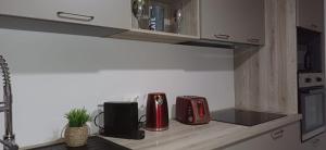 a kitchen counter with two red appliances on it at Éden Home Accès Rivière Privée in Goyave +18 photos