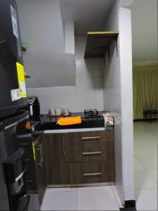 a small kitchen with a sink and a refrigerator at Confortable Apartamento Norte de Popayán in Popayan +3 photos