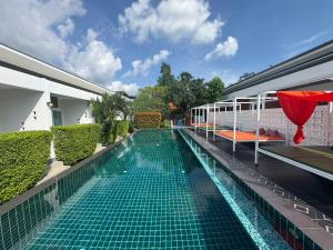 a swimming pool in the middle of a house at Phangan Hometown Resort - Adults Only in Ban Tai