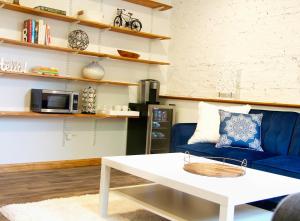 a living room with a blue couch and a coffee table at Brighton guest suite in Boston