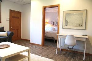 a living room with a bed and a table with a chair at Brighton guest suite in Boston +3 photos