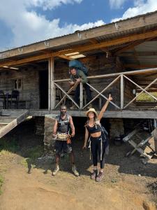 a man and a woman standing in front of a house at Hike mount mulanje with Harry in Lilongwe