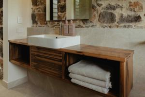 a bathroom with a vanity with a sink and towels at Cosy 2 bedroom cottage with rural farmland views in Ross Creek +50 photos