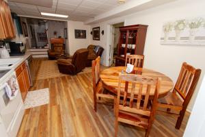 a kitchen and dining room with a wooden table and chairs at O'Brien's Sanctuary in Candler
