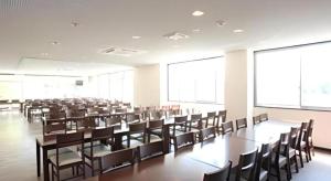 an empty lecture room with tables and chairs at Hotel SP Haruno in Shinkawa