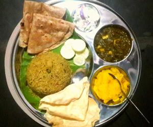 a plate of food with different types of food on it at Coconut Homestay Hampi in Hampi