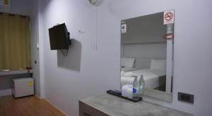 a room with a bathroom with a mirror and a bed at C2U Hotel Uthai Thani in Ban Khok Mo +52 photos