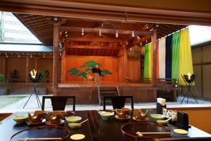 a dining room with a table and a stage at Yamatoya Honten in Matsuyama +98 photos