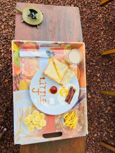 a lunch box with a plate of food on a table at Little J villa in Dickwella