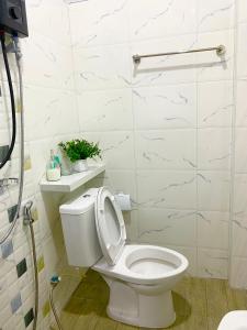 a bathroom with a white toilet and a shower at Singgah Homestay Yala in Ban Sarong +14 photos