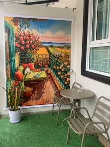 a mural of a balcony with a table and chairs at Singgah Homestay Yala in Ban Sarong