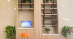 a room with a computer on a shelf with plants at Green Tree Inn Express Hefei Yungu Road Linhu Community in Hefei