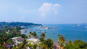 a view of a beach with boats in the water at Sithujaya Green Mirissa in Mirissa
