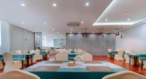 a banquet hall with blue tables and white chairs at Borrman Hotel Liuzhou High-Speed Railway Station in Liuzhou