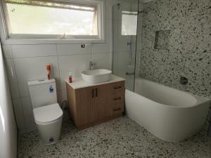 a bathroom with a toilet and a tub and a sink at My Sweet Bonnie in Bonnie Doon +14 photos