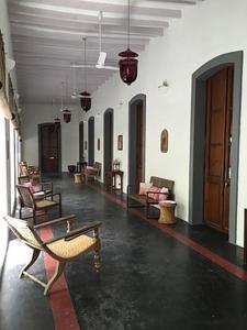 a room with chairs and tables in a building at Villa Helena in Puducherry