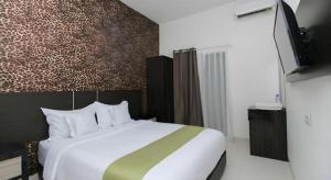 a bedroom with a large bed and a tv at Arotel BSD in Tangerang +54 photos