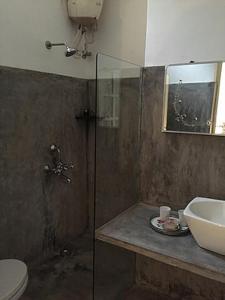a bathroom with a shower and a sink and a toilet at Villa Helena in Puducherry