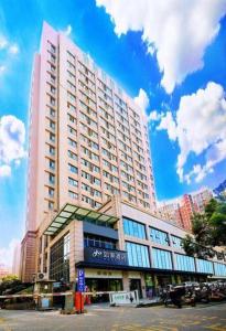 a large building in front of a building at City Comfort Inn Hotel Wuhan Optics Valley Square Metro Station Zhongnan Minzu University in Wuhan