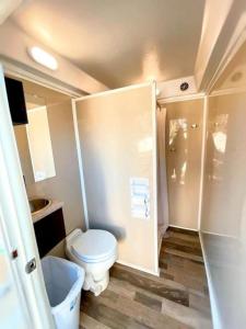 a small bathroom with a toilet and a shower at Stunning Glamping Destination Ideal for a Relaxing Vacation: Luxury Safari Tent on the San Marcos River near Kingsbury, Texas in Staples