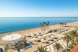 an overhead view of a beach with chairs and umbrellas at Le Meridien Ra Beach Hotel and Spa in El Vendrell