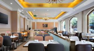 a restaurant with tables and chairs in a room at Vienna Hotel Guangzhou Yonghe Development Zone in Guangzhou