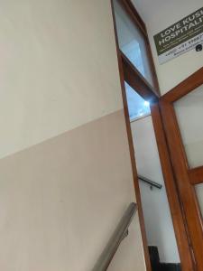 a room with a window and a wooden door at Love kush hospitalitie in Ujjain