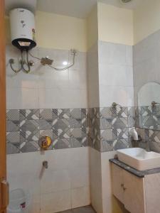 a bathroom with a sink and a toilet and a mirror at Love kush hospitalitie in Ujjain