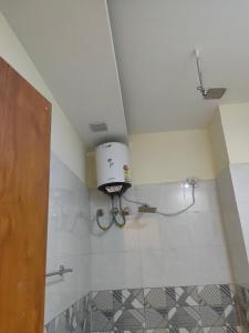 a bathroom with a toilet in the corner of a room at Love kush hospitalitie in Ujjain