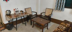 a room with a table and chairs and a table and a table and a table at Hotel Purvanchal in Katihār