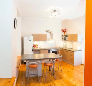 a kitchen with a table and some chairs in it at Rataskaevu Guest Apartment in Tallinn